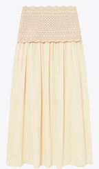 A light cream or pale yellow pleated skirt with a textured crochet lace waistband, shown against a plain white background.