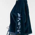 Dark blue kimono-style garment with floral embroidery on a plain background