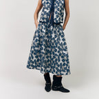 Woman wearing a blue floral dress on a white background