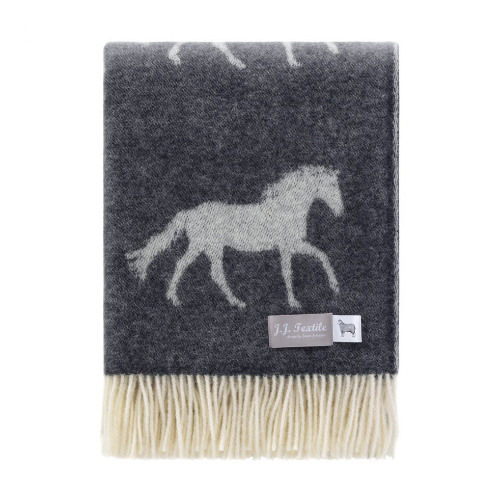 Gray throw blanket with horse design and brand label on a white background