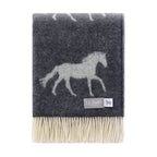 Gray throw blanket with horse design and brand label on a white background