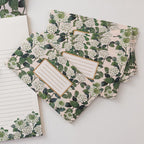 Floral-patterned notebooks on a white surface