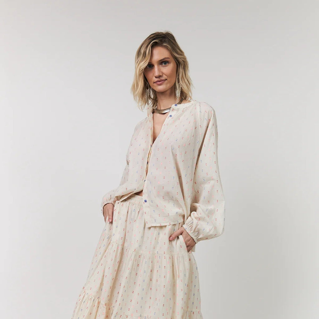 Woman wearing a beige outfit with a white background