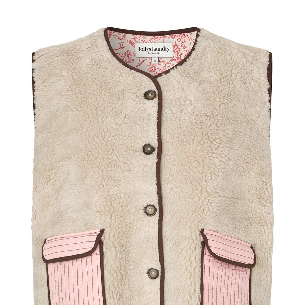 Beige fleece vest with pink accents on a white background