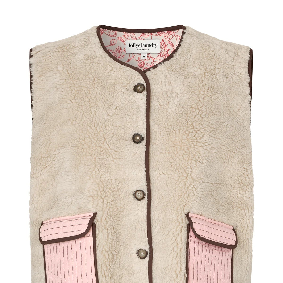 Beige fleece vest with pink accents on a white background