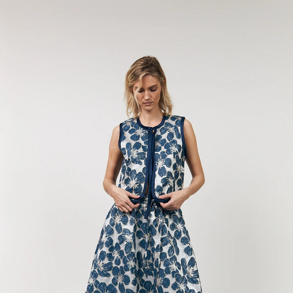 Woman wearing a blue floral dress on a white background