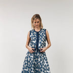Woman wearing a blue floral dress on a white background