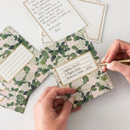 Floral stationery set with envelopes and cards on a light surface