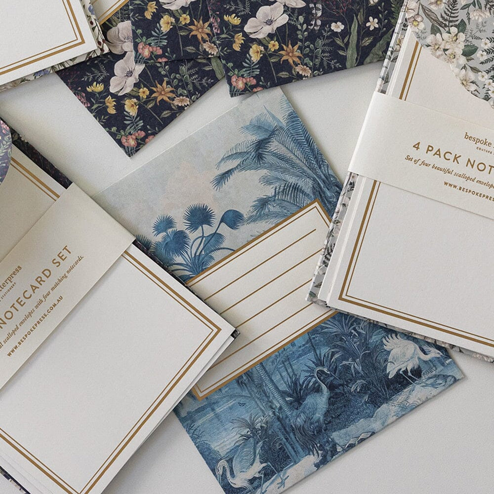 Collection of floral and nature-themed notecards on a white surface