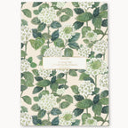 Notebook with green floral pattern on a white background
