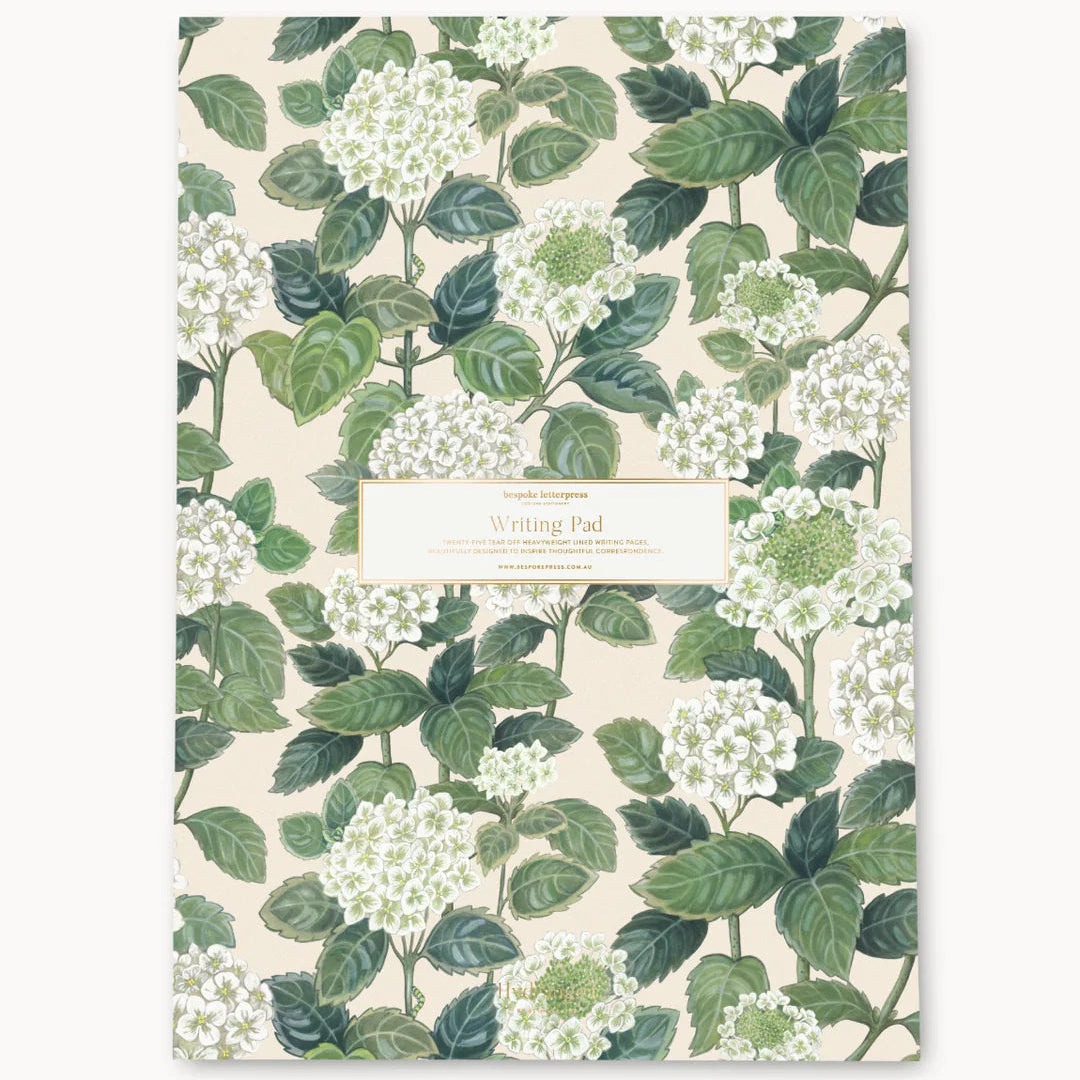 Notebook with green floral pattern on a white background