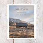 Poster of a cabin in a field with mountains in the background, titled 'Lodestars Anthology New Zealand'.