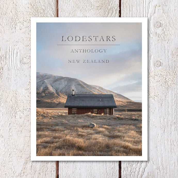 Poster of a cabin in a field with mountains in the background, titled 'Lodestars Anthology New Zealand'.