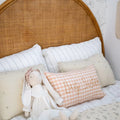 Bed with pillows and a doll, featuring a 'Big Sister' pillow.